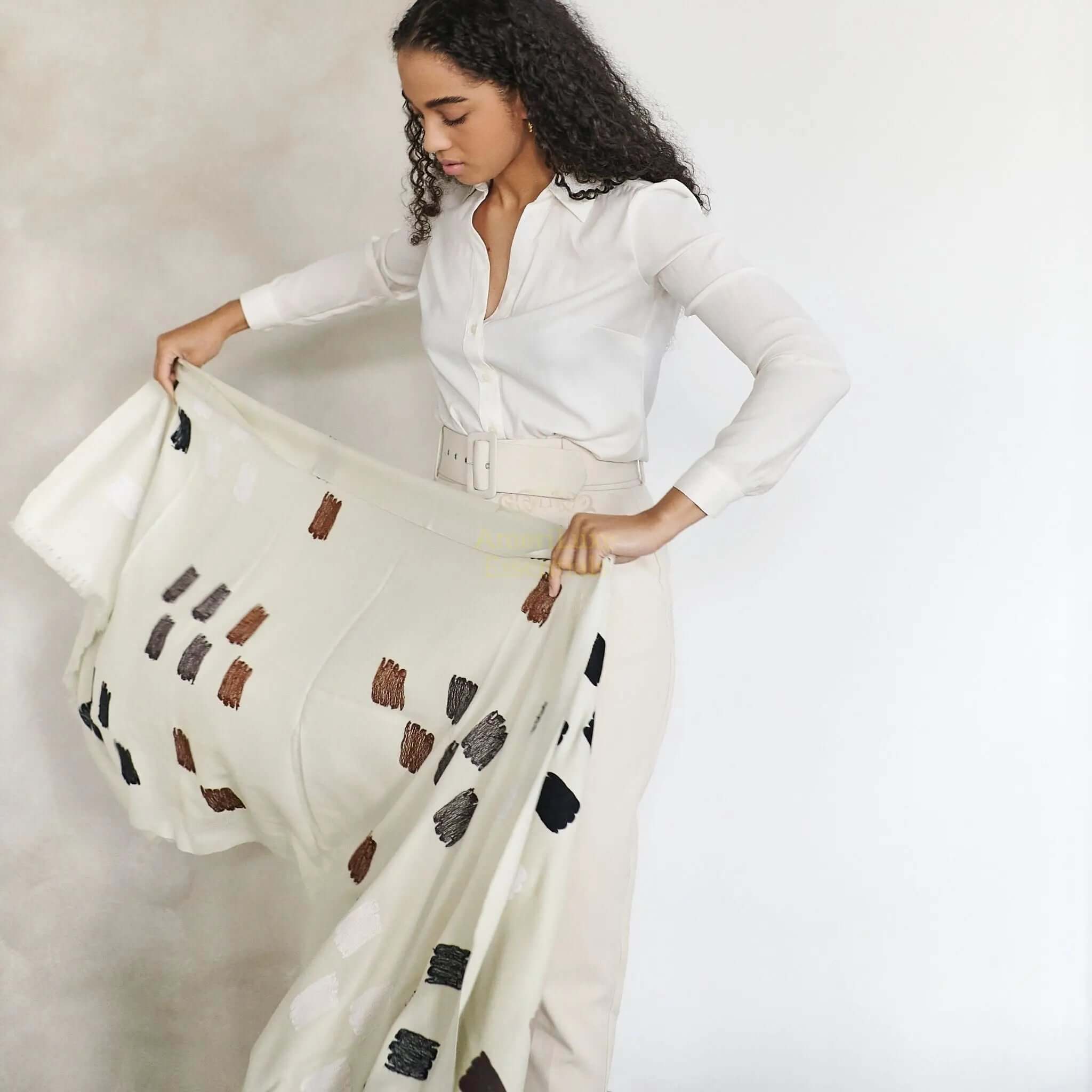 Woman styling the Off White embroidered scarf, showcasing the hand woven embroidered scarf from Kashmir.