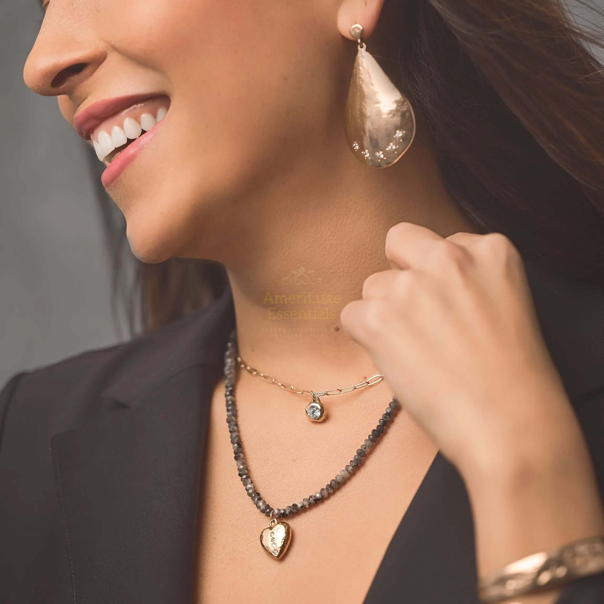 Close-up of a woman wearing Parisian designer earrings, showcasing their elegant teardrop shape and polished bronze finish.