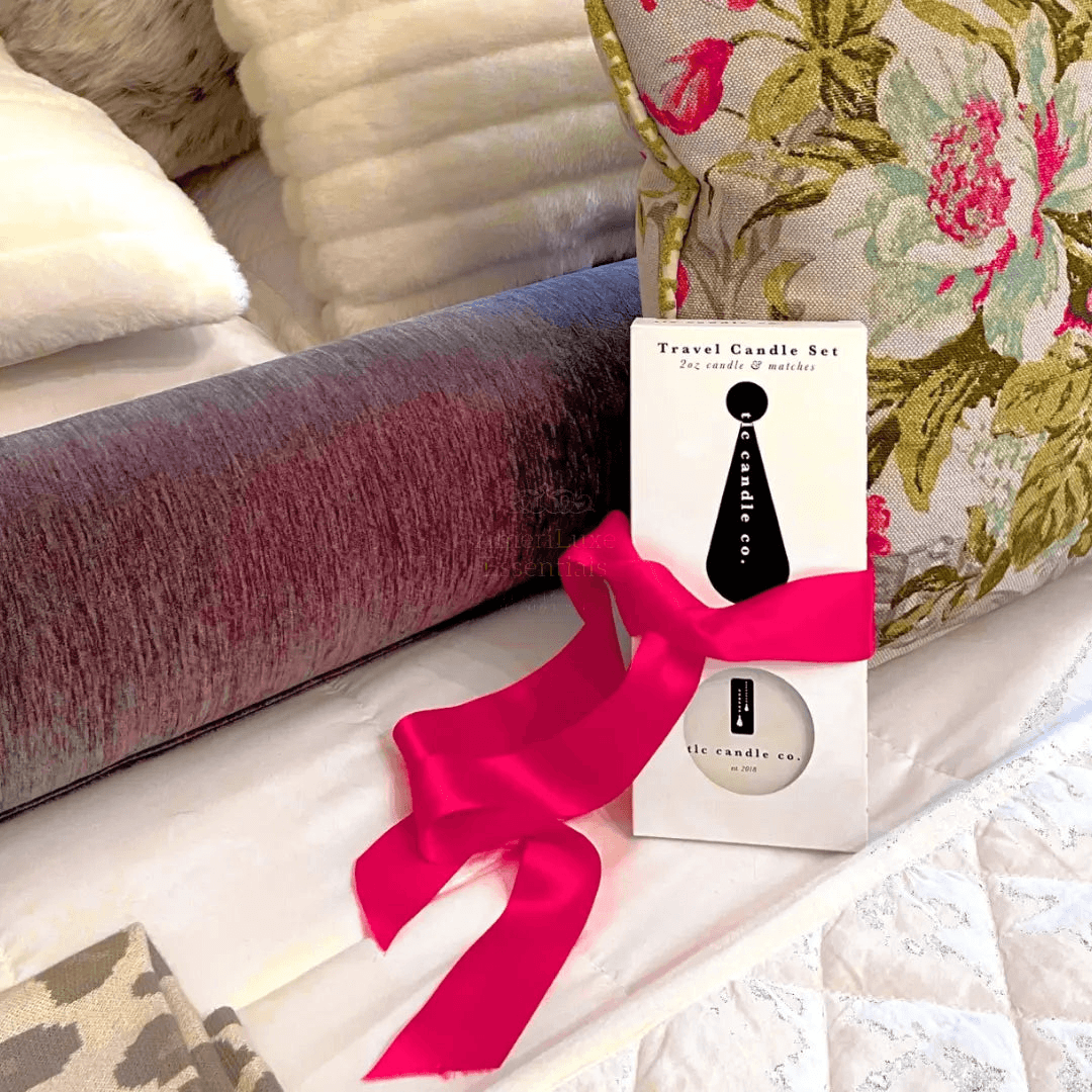 Coastal travel scented candles set displayed with a travel candle kit and decorative pillows.