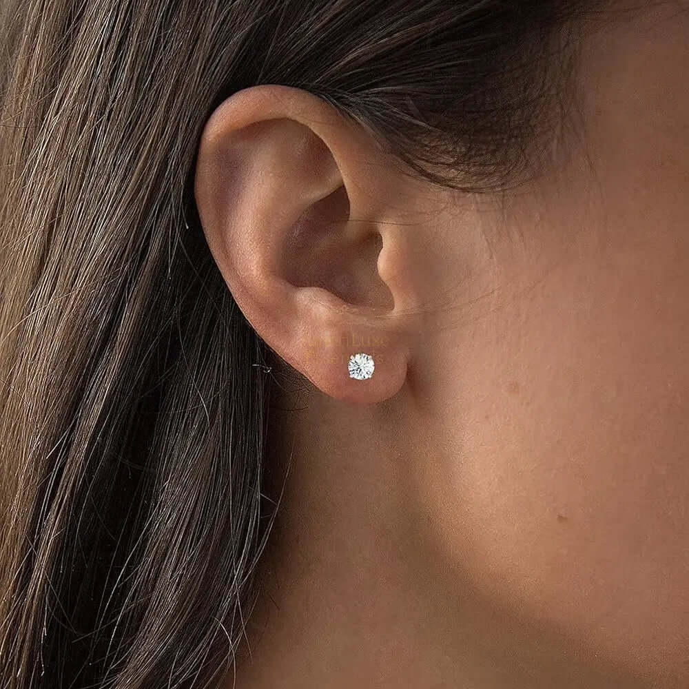 Model wearing ethical lab-grown diamond stud earrings in 14K gold, showcasing F-G color and VS clarity.