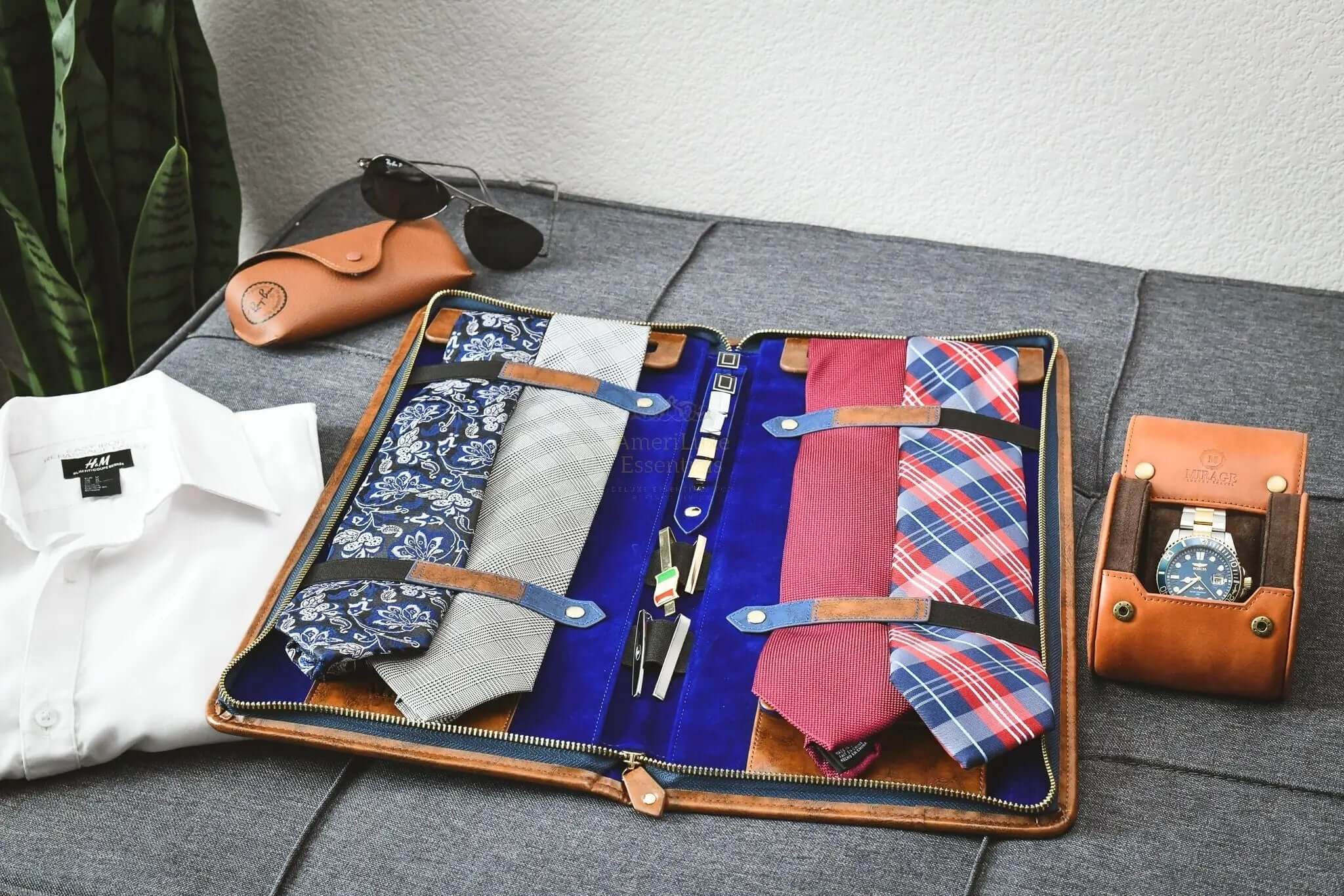 Travel tie organizer case displaying ties, collar stays, and accessories for stylish travel.