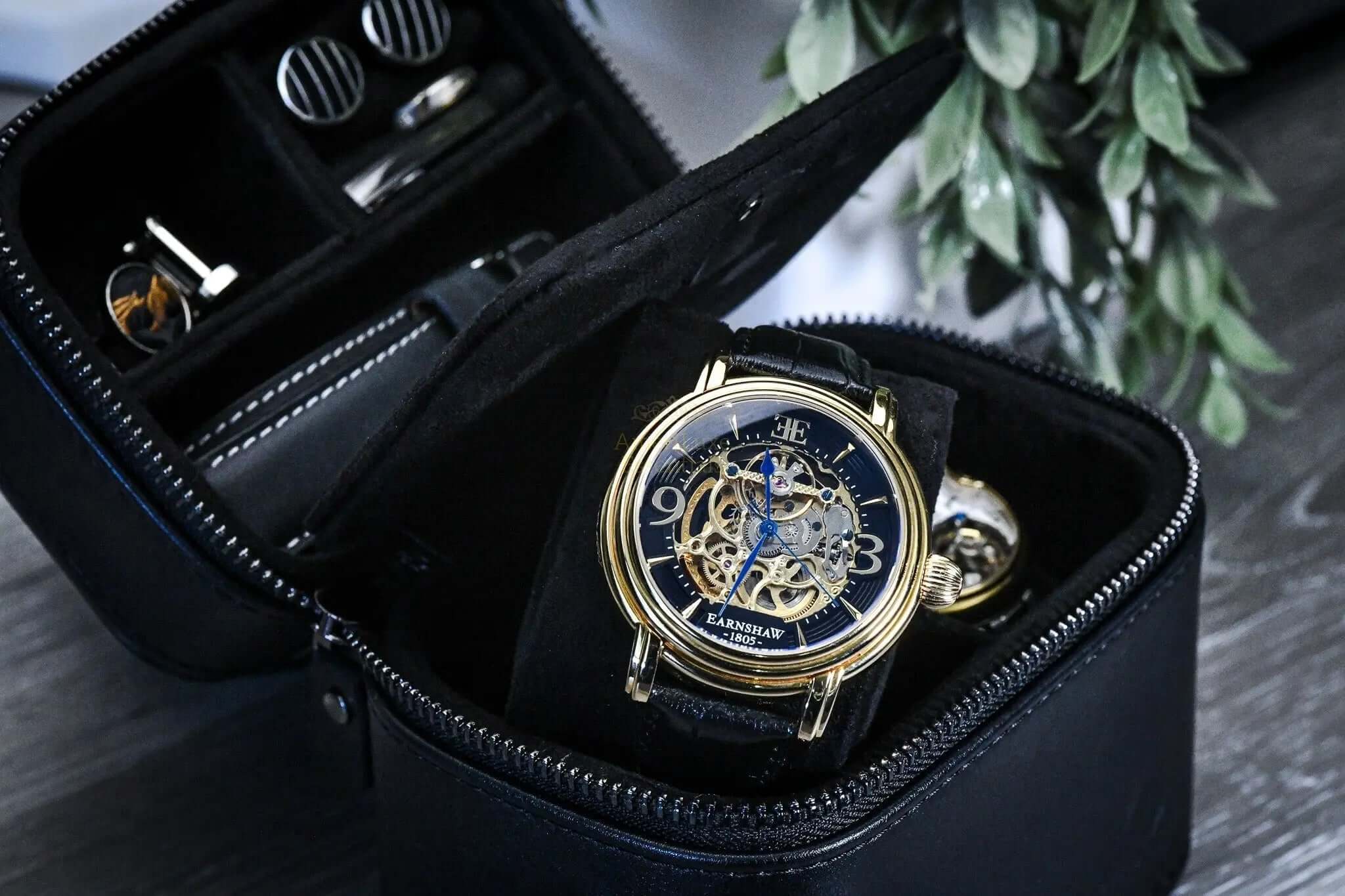 genuine leather watch travel case with a detailed gold watch and compartments for accessories