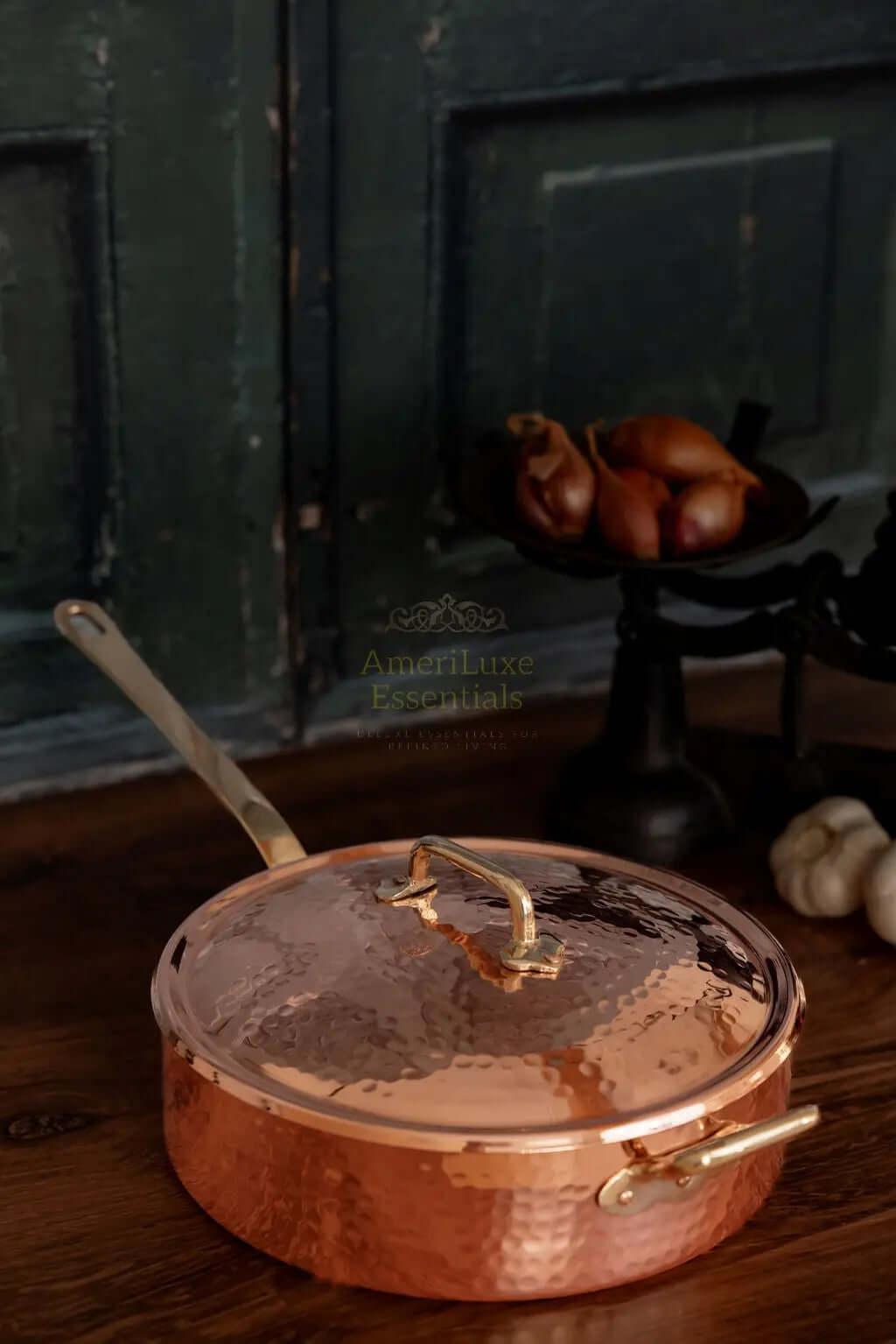 CMK Farmhouse Kitchen Copper Large Saute Pan on wooden countertop with decorative fruits in the background.