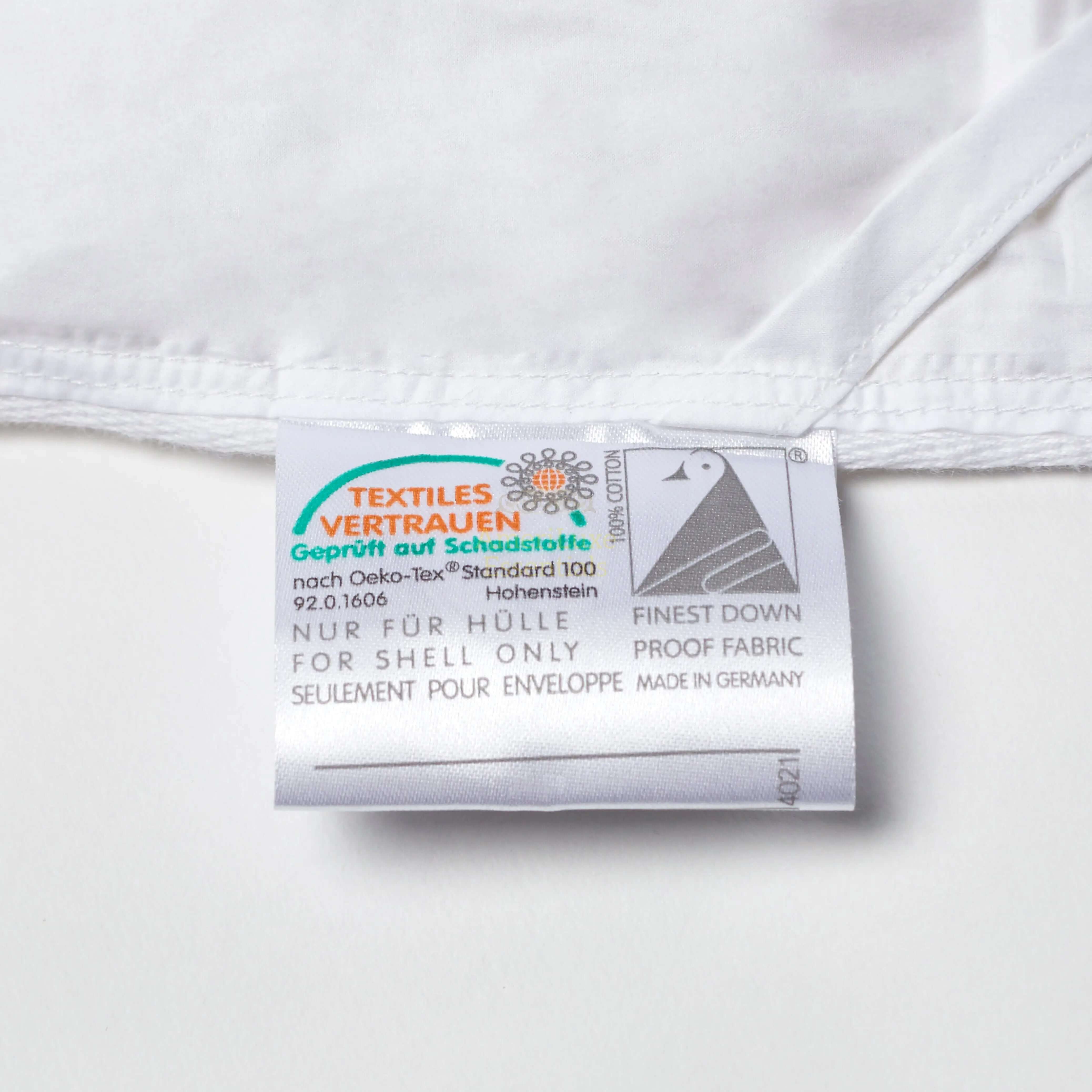 Premium white goose down comforter label showing textile safety certification and down-proof fabric details.