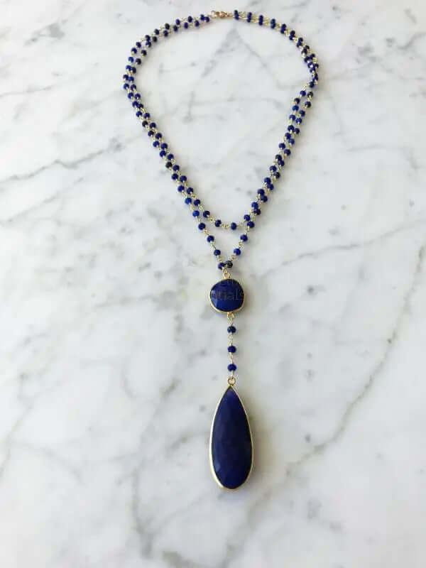 Double sapphire necklace featuring a blue sapphire drop pendant and elegant bead design.