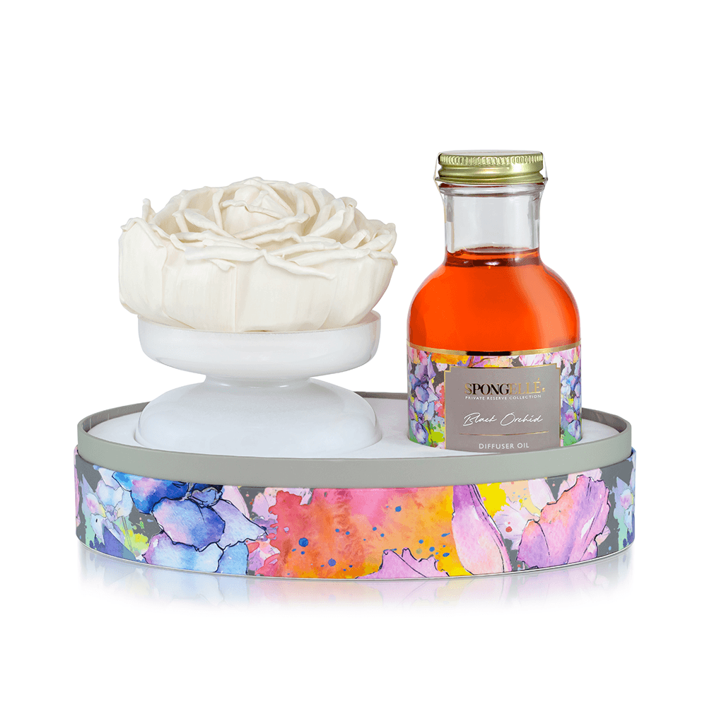 Black Orchid - Private Reserve Diffuser set with white flower and diffuser oil in colorful packaging.