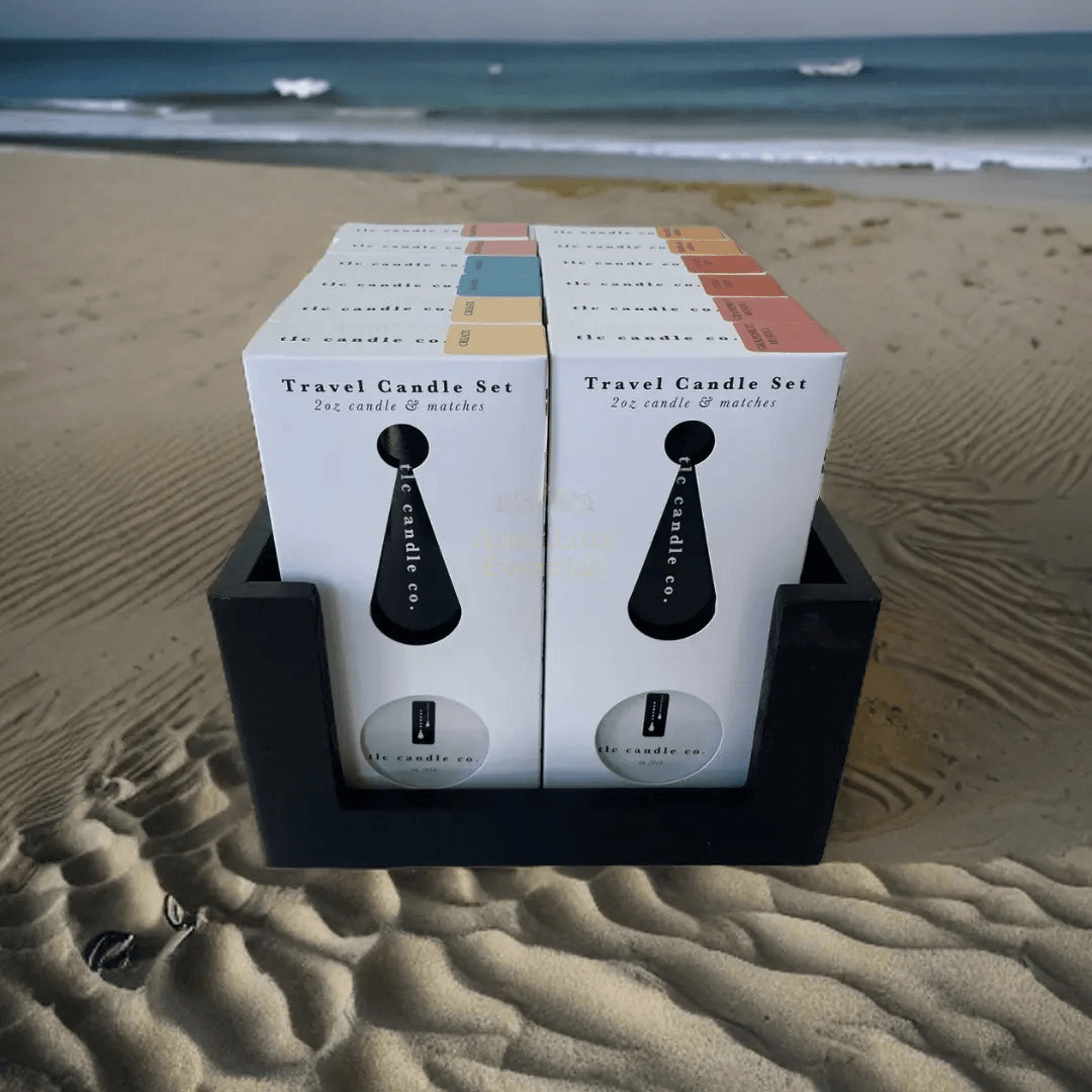 Coastal travel scented candles set displayed on a sandy beach, perfect for enhancing your travel experience.
