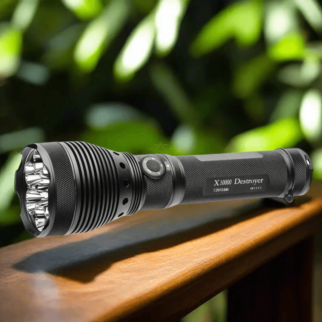 Destroyer-X10K-GEN2-9,500-Lumen-Search-Light-on-wooden-surface-with-greenery-background