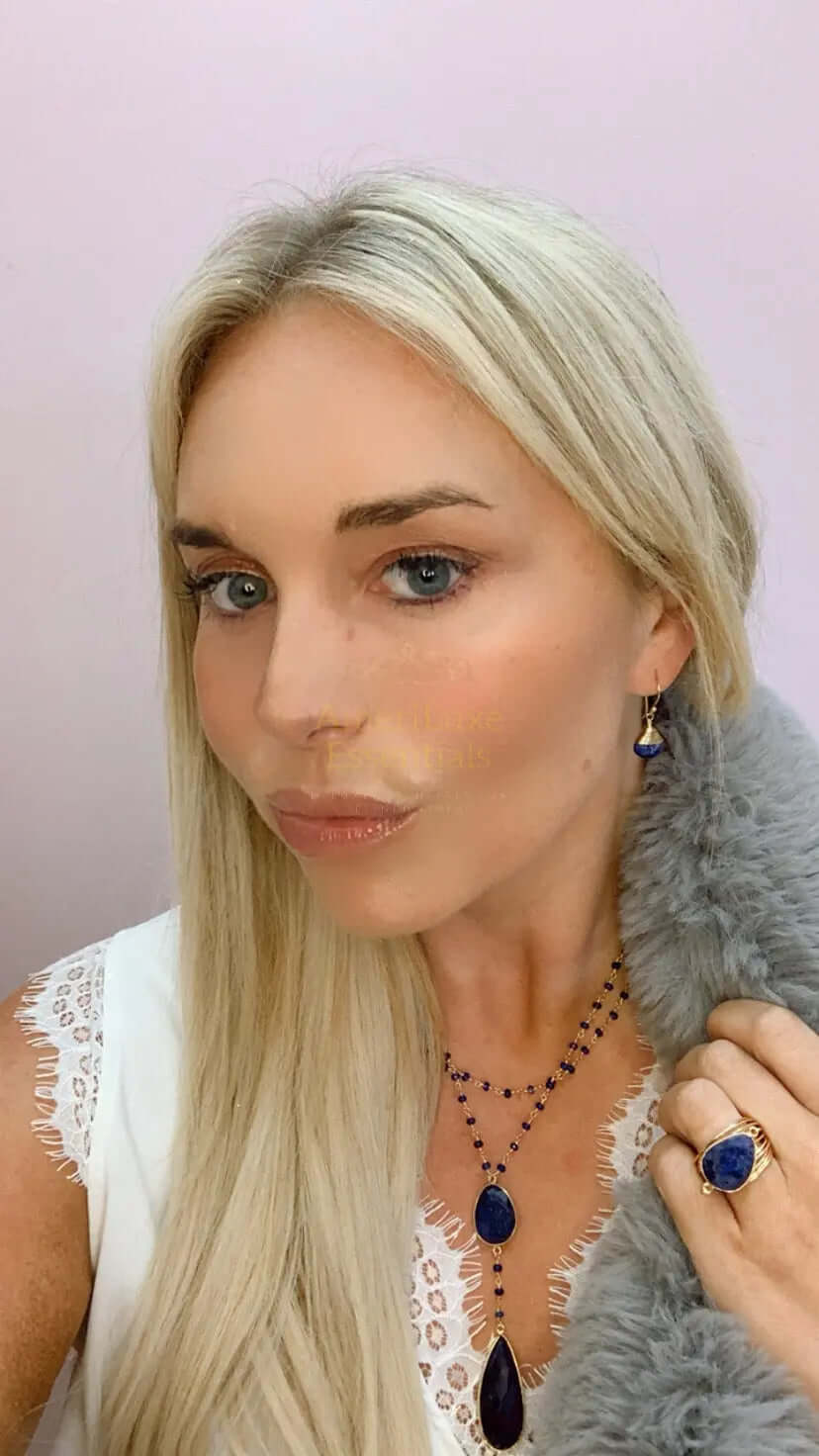 Model wearing a double sapphire necklace with sapphire drop, showcasing elegance and luxury.