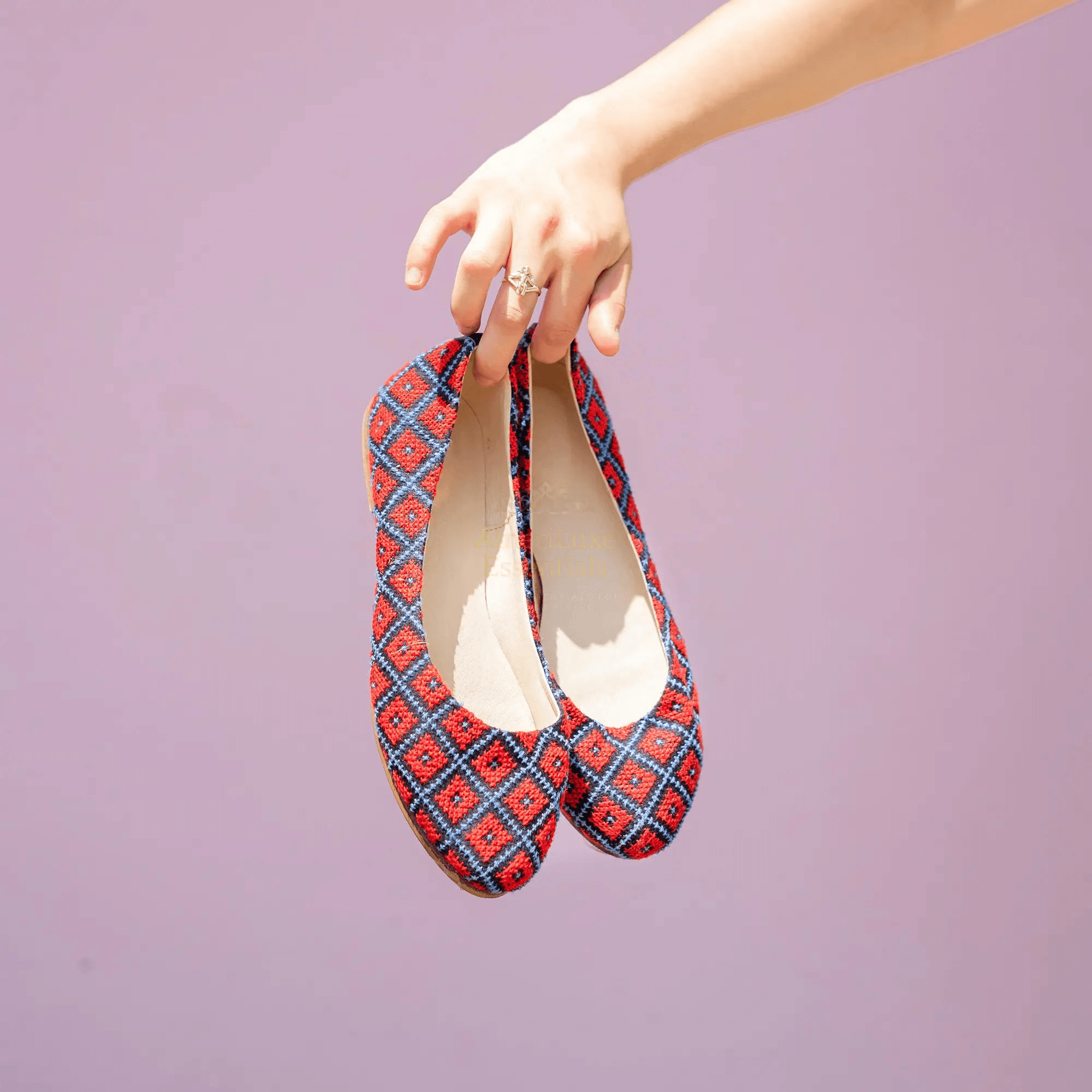 Yasmin Cardinal Red Comfortable Flat Shoes held in hand, featuring traditional tatreez embroidery, stylish and comfortable flat shoes.