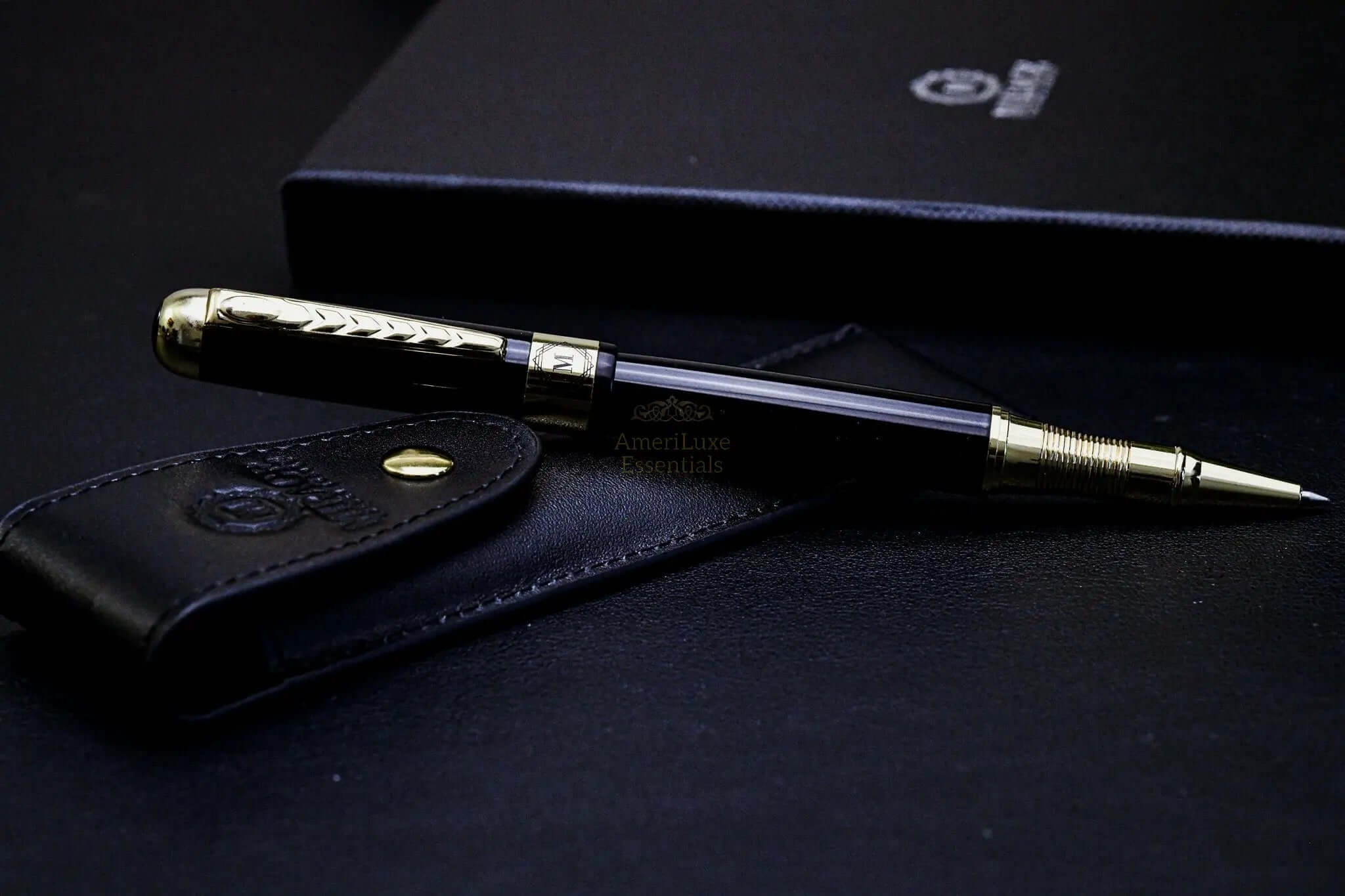 Mirage luxury black pen with golden accents on stylish leather case and notebook.