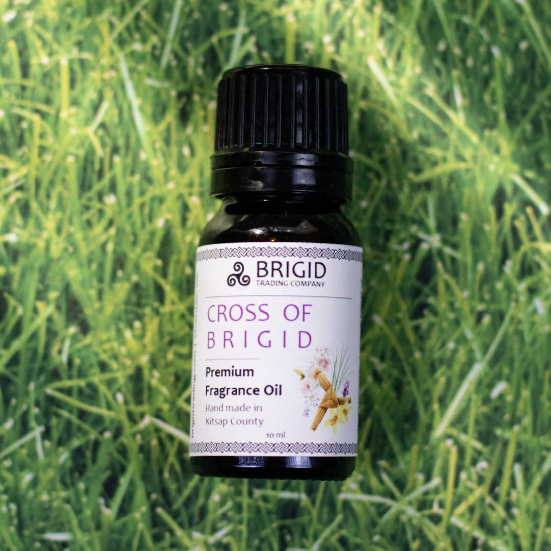 Diffuser Oil Blends - Essential and Premium Fragrance Blends bottle of Cross of Brigid premium fragrance oil on green grass.
