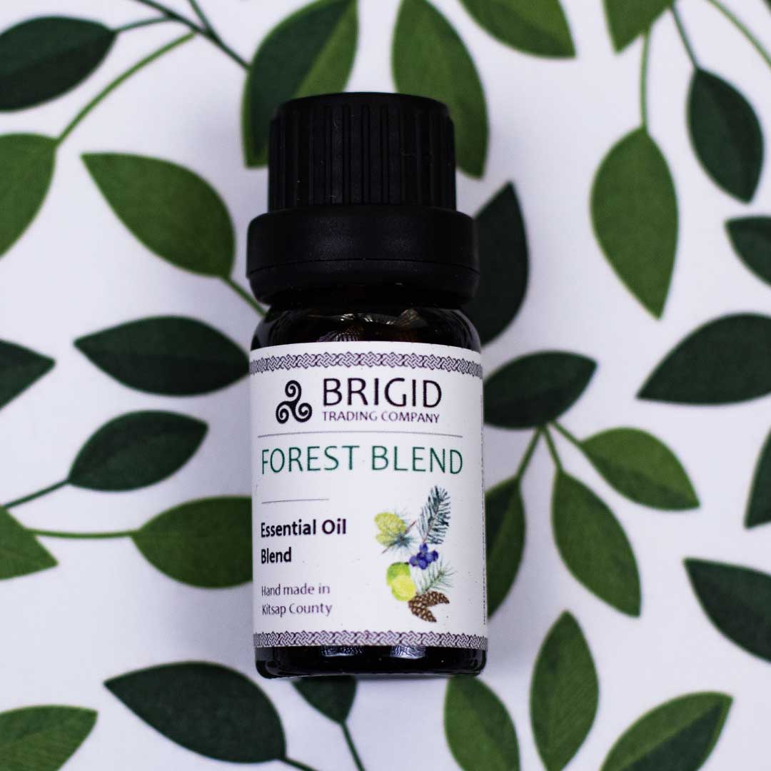 Diffuser Oil Blends - Essential and Premium Fragrance Blends, Brigid's Forest Blend essential oil bottle on a leaf background.